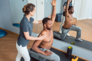 physiotherapist assisting patient to exercise